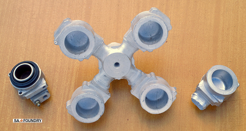 "Cluster" of the castings of the front aluminum brake calipers obtained by the LPDC method and also one caliper in assembling state